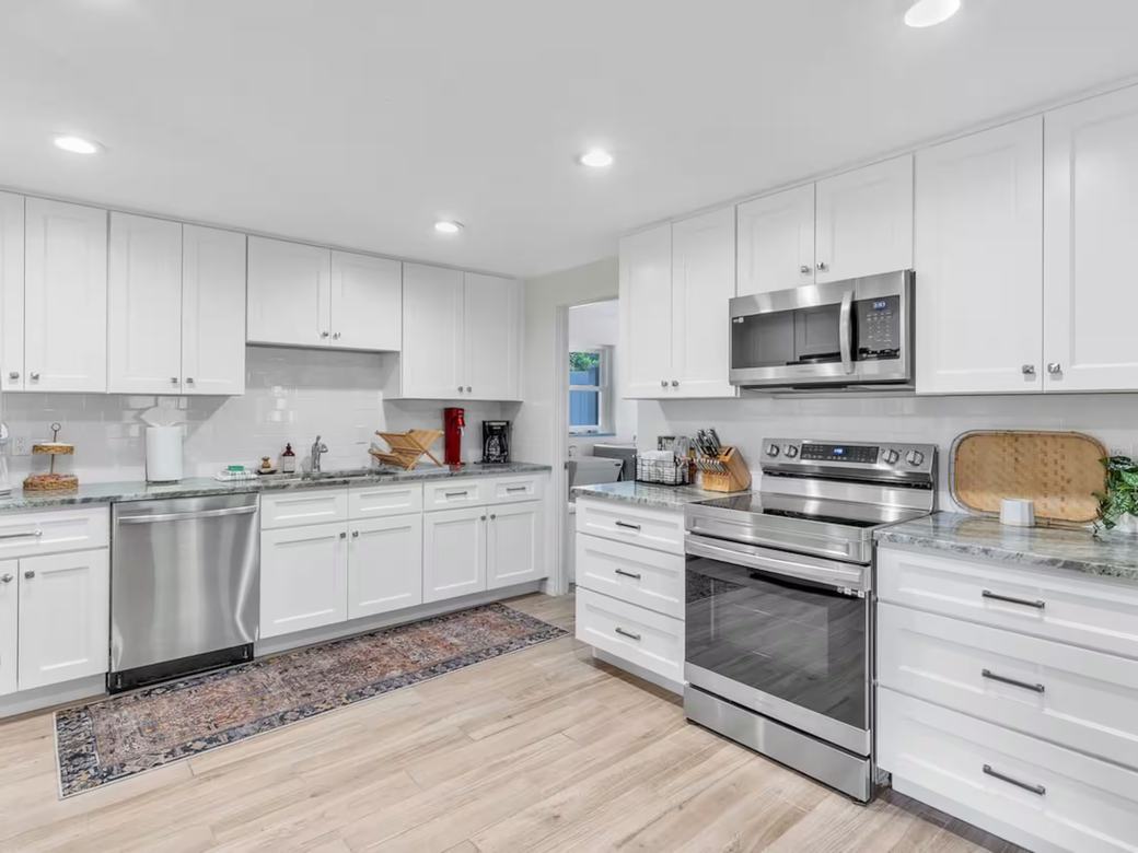 A deep-cleaned kitchen with spotless cabinets, range and countertops